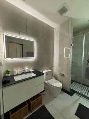 a bathroom with a toilet and a sink and a shower at Bali Essence, The Title BangTao in Bang Tao Beach