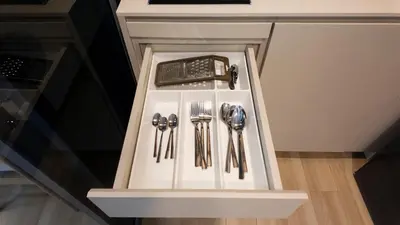 a drawer with silver utensils in a kitchen at Natural Harmony - SkyPark Celeste in Laguna Phuket