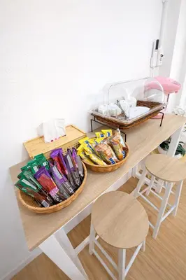 two baskets on a table with two stools at Phuket gateway inn in Ban Kathu