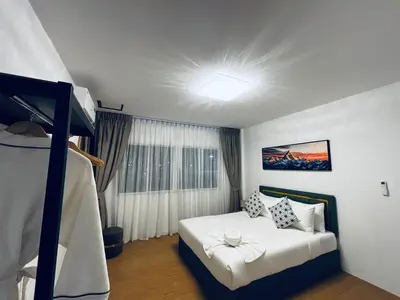 a bedroom with a bed and a ceiling with a light at Phuket gateway inn in Ban Kathu