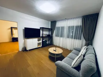a living room with a couch and a table at Phuket gateway inn in Ban Kathu