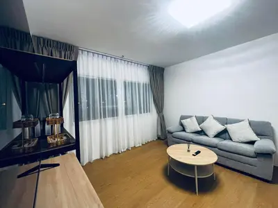 a living room with a couch and a coffee table at Phuket gateway inn in Ban Kathu