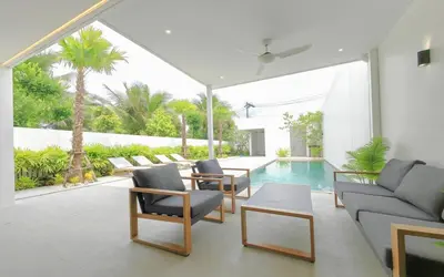 a living room with a couch and chairs and a pool at Luxury Private Christina Pool Villa in Ban Phak Chit