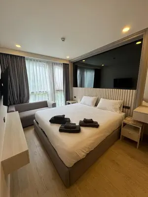 a bedroom with a large bed with two towels on it at Пляж Бангтао Резиденция Ozon in Laguna Phuket