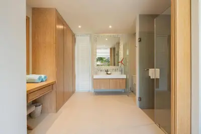a bathroom with a sink and a mirror at The Sandstone Villa at Trichada Breeze in Laguna Phuket
