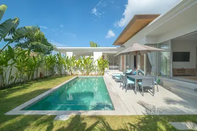 a backyard with a swimming pool and a villa at The Sandstone Villa at Trichada Breeze in Laguna Phuket