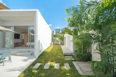 an internal courtyard of a house with a garden at The Sandstone Villa at Trichada Breeze in Laguna Phuket