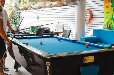 a man playing a game of pool in a garage at Patong hillside Condo with pool, bar, parking in Patong Beach