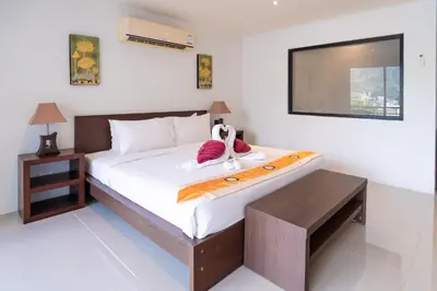 a bedroom with a bed with a stuffed animal on it at Patong hillside Condo with pool, bar, parking in Patong Beach