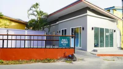 a building with a sign in front of it at Tiny house bangtao in Ban Thalat Choeng Thale