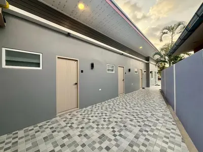 a hallway of a building with a row of doors at Tiny house bangtao in Ban Thalat Choeng Thale