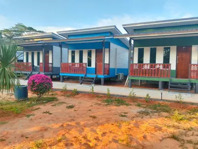 a row of houses with benches in front of them at The Nap Koh Yao Yai in Ban Nai Wat