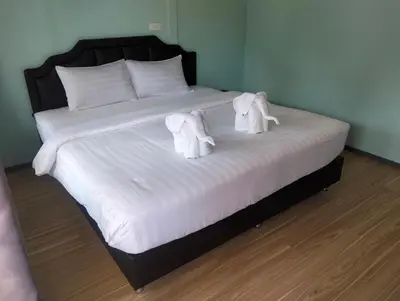 a bed with towels on top of it at The Nap Koh Yao Yai in Ban Nai Wat