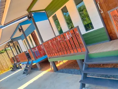 a row of benches sitting outside of a house at The Nap Koh Yao Yai in Ban Nai Wat