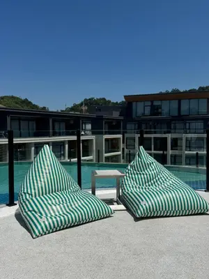 two pillows sitting next to a table in front of a building at Wyndham apartment Naithon in Nai Thon Beach