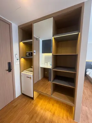a room with a large closet with wooden shelves at Wyndham apartment Naithon in Nai Thon Beach