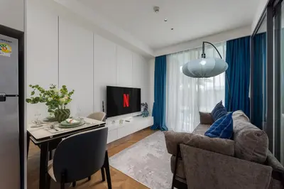 a living room with a couch and a table at Lamia 1BR Suite at Kora Beach Resort in Layan Beach