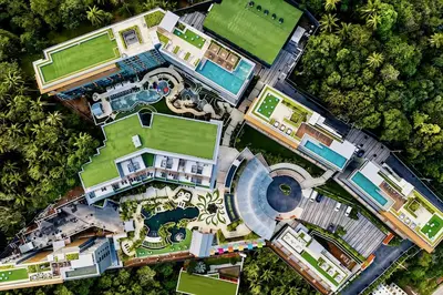 an aerial view of a mansion with a swimming pool at Mida Grande Surin Private Suites in Ban Lum Fuang