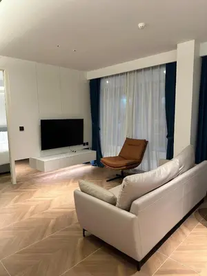 a living room with a white couch and a chair at Kora Beach Resort Residence 2 bedroom by Ere in Layan Beach