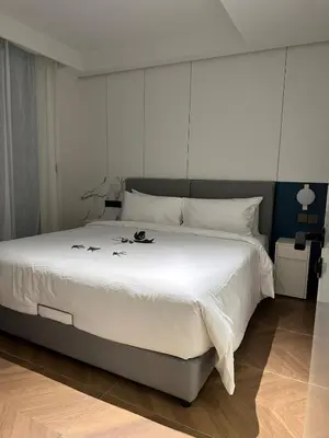 a bedroom with a large bed with white sheets at Kora Beach Resort Residence 2 bedroom by Ere in Layan Beach