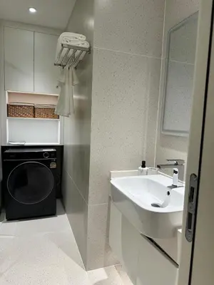 a bathroom with a sink and a washing machine at Kora Beach Resort Residence 2 bedroom by Ere in Layan Beach