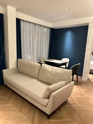 a living room with a white couch and a table at Kora Beach Resort Residence 2 bedroom by Ere in Layan Beach