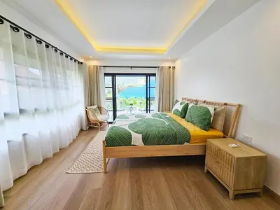 a bedroom with a bed and a large window at Boutique pool villa in Soi Bell,Kamala in Kamala Beach