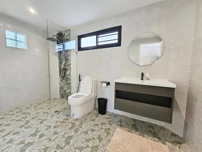 a bathroom with a toilet and a sink and a mirror at Boutique pool villa in Soi Bell,Kamala in Kamala Beach