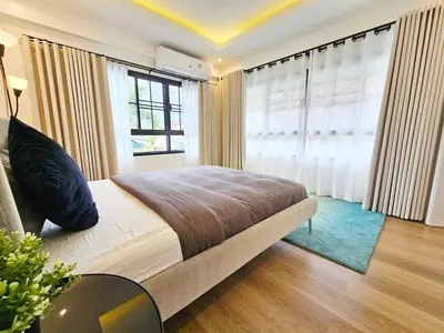 a bedroom with a bed and a large window at Boutique pool villa in Soi Bell,Kamala in Kamala Beach