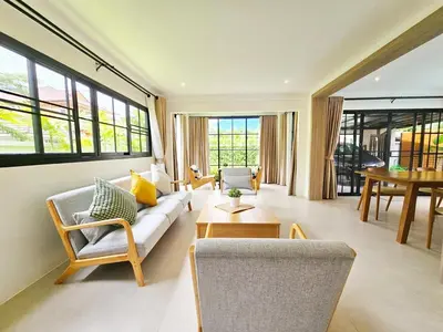 a living room with a couch and a table at Boutique pool villa in Soi Bell,Kamala in Kamala Beach