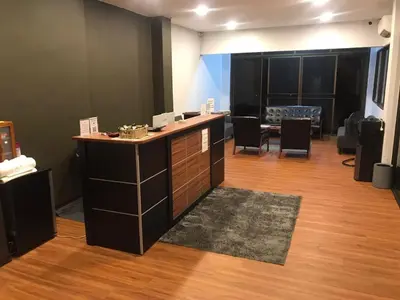 a room with a counter with chairs and a table at Karon Place in Ban Karon