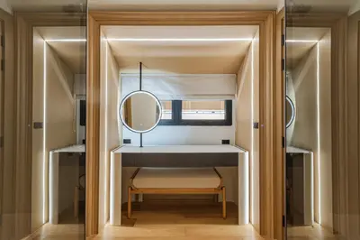 a dressing room with a mirror and a chair at PRAIA Residence 5BR - Bangtao in Ban Pak Lak