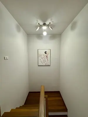 a room with a ceiling fan and a painting on the wall at KONE- 3BR Private Pool Villa Kathu near Patong in Ban Kathu