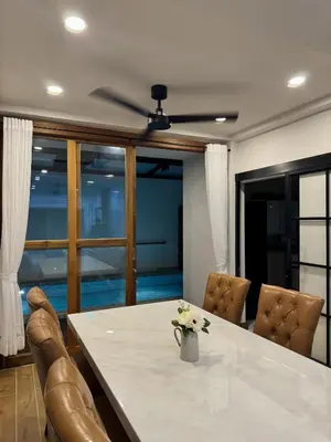 a dining room with a table and leather chairs at KONE- 3BR Private Pool Villa Kathu near Patong in Ban Kathu