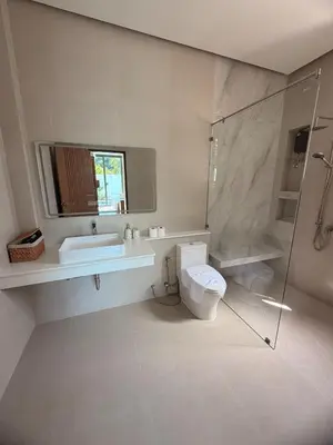 a bathroom with a toilet and a sink and a shower at Chareen Pool Villa in Ban Khlong Haeng