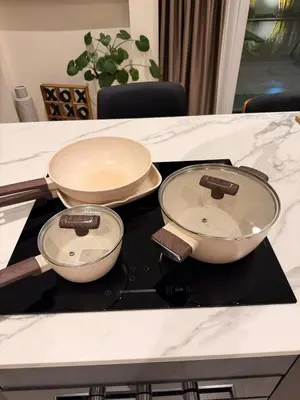 three pans sitting on top of a stove at Chareen Pool Villa in Ban Khlong Haeng