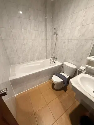a bathroom with a tub and a toilet and a sink at Nova Inn in Patong Beach