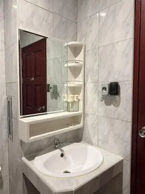 a bathroom with a sink and a mirror at Nova Inn in Patong Beach