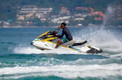 a man riding a jet ski in the water at GO INN Patong - โกอินน์ ป่าตอง in Patong Beach