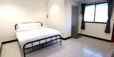 a bedroom with a white bed and a window at GO INN Patong - โกอินน์ ป่าตอง in Patong Beach