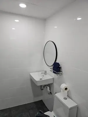 a bathroom with a toilet and a mirror on the wall at Large 1 Bedroom Apt Sleeps 4, Close to Beach - RM 2 in Ban Lum Fuang