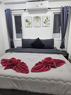 a bed with two red robes on top of it at Large 1 Bedroom Apt Sleeps 4, Close to Beach - RM 1 in Ban Lum Fuang