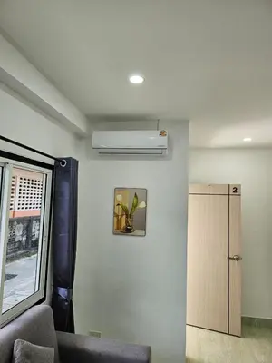 a living room with a couch and a ceiling fan at Large 1 Bedroom Apt Sleeps 4, Close to Beach - RM 1 in Ban Lum Fuang