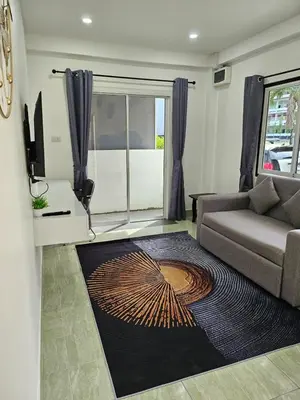 a living room with a couch and a rug at Large 1 Bedroom Apt Sleeps 4, Close to Beach - RM 1 in Ban Lum Fuang