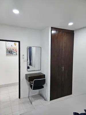 a bathroom with a sink and a wooden door at Large 1 Bedroom Apt Sleeps 4, Close to Beach - RM 1 in Ban Lum Fuang