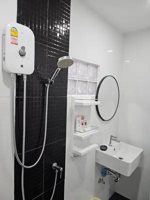 a bathroom with a shower and a sink and a mirror at Large 1 Bedroom Apt, Sleeps 4, close to beach - RM 4 in Ban Lum Fuang