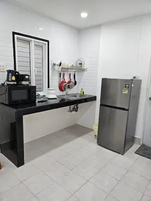 a kitchen with a counter and a refrigerator at Large 1 Bedroom Apt, Sleeps 4, close to beach - RM 4 in Ban Lum Fuang