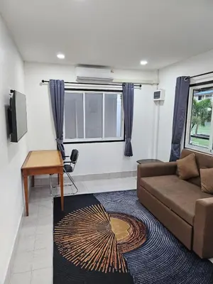 a living room with a couch and a table at Large 1 Bedroom Apt, Sleeps 4, close to beach - RM 4 in Ban Lum Fuang