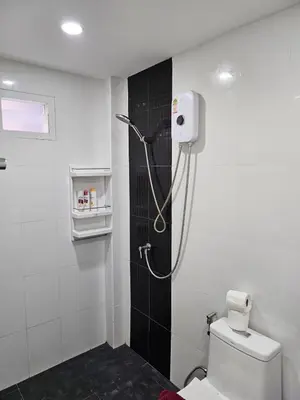 a bathroom with a shower with a toilet in it at Large 1 Bedroom Apt, Sleeps 4, close to beach - RM 4 in Ban Lum Fuang