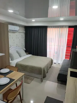 a hotel room with a bed and a table and a tableablish at 777 Condo Phuket in Ban Mai Salae
